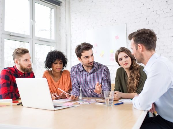 Creative agency meeting - group of business people talking during conference at office